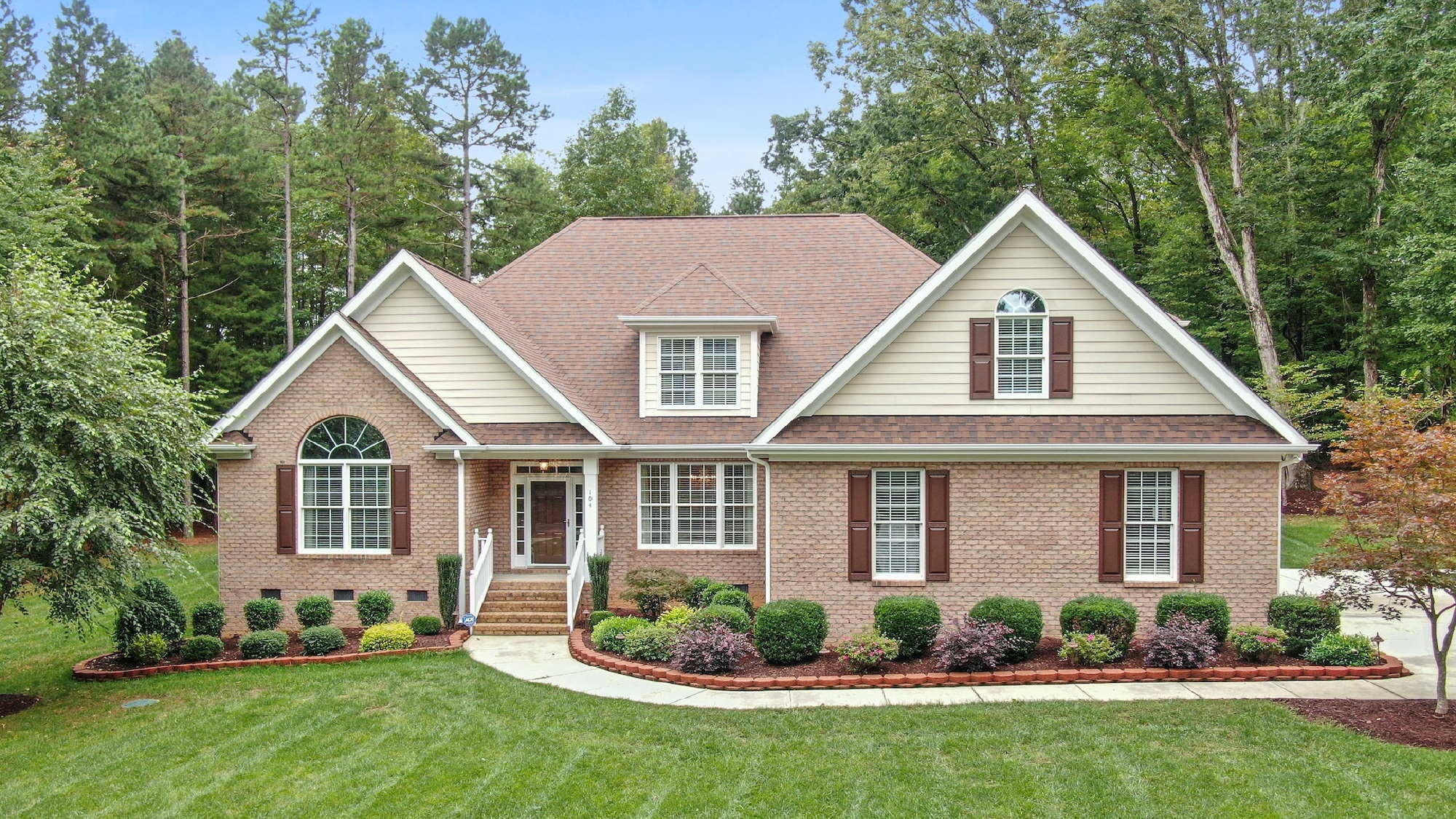 Couple sitting together on couch looking at laptop