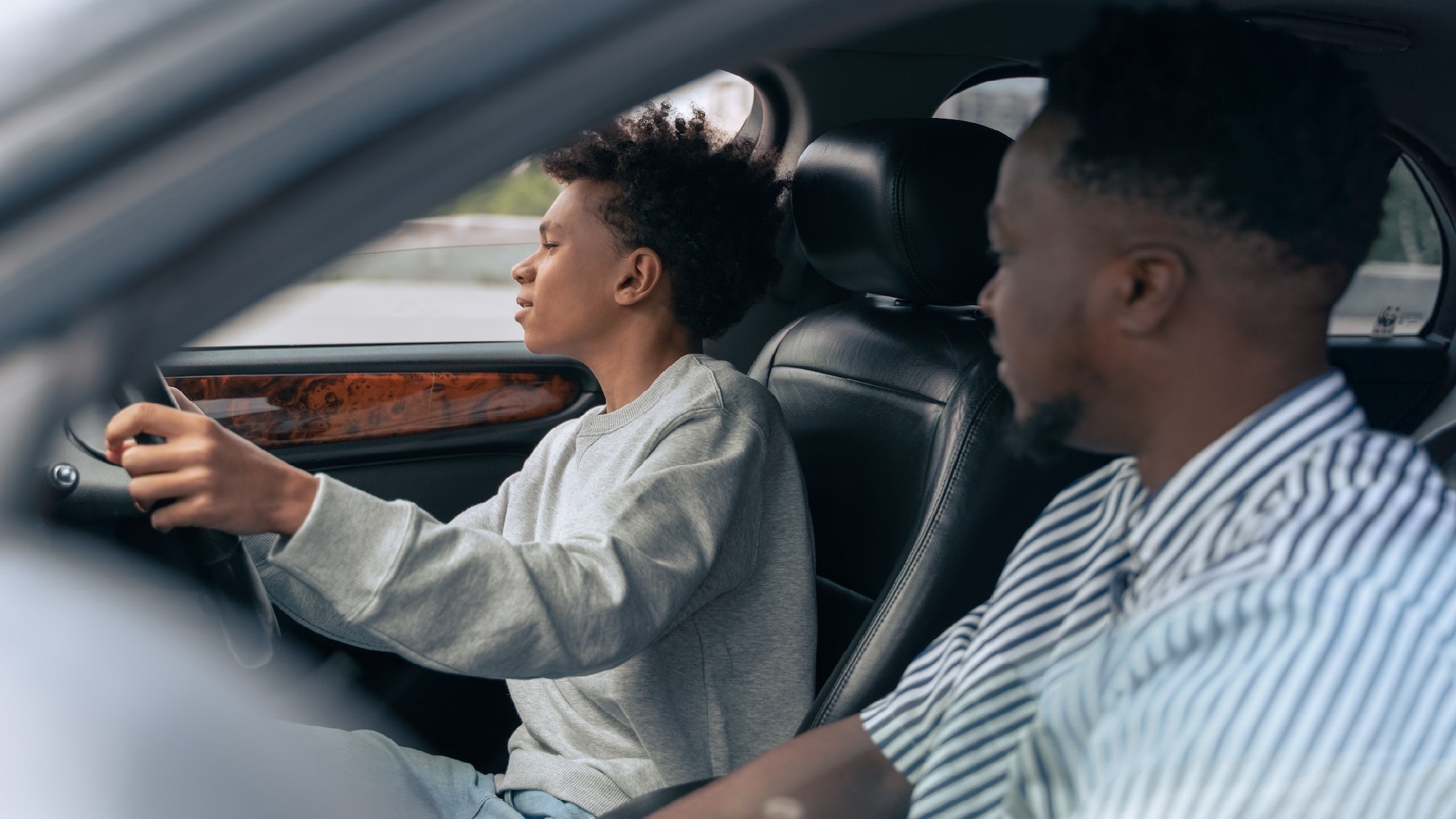 Couple sitting together on couch looking at laptop
