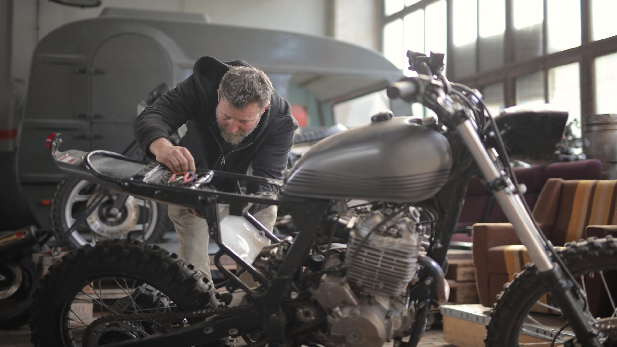 Couple sitting together on couch looking at laptop